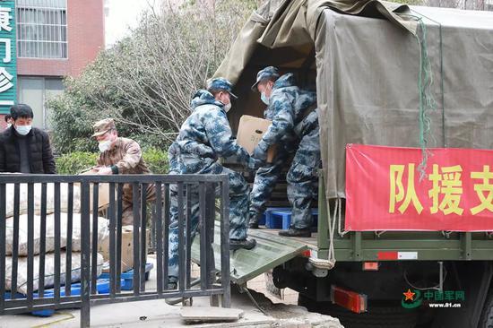 官兵正在装载要运送到武汉市各大超市的物资。洪培舒 摄